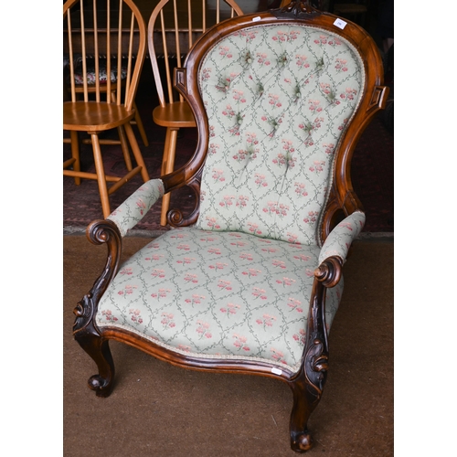 196 - A Victorian walnut framed salon armchair with pale green floral pattern fabric