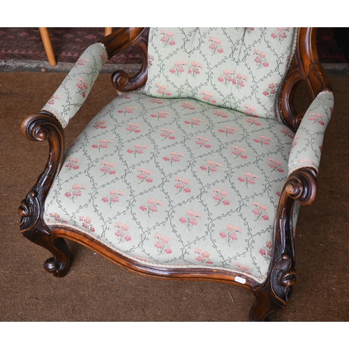 196 - A Victorian walnut framed salon armchair with pale green floral pattern fabric