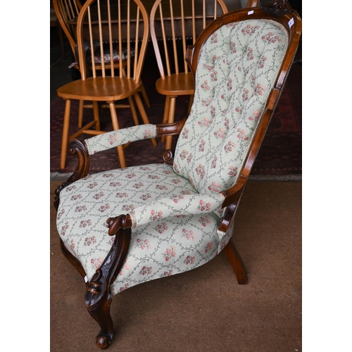 196 - A Victorian walnut framed salon armchair with pale green floral pattern fabric