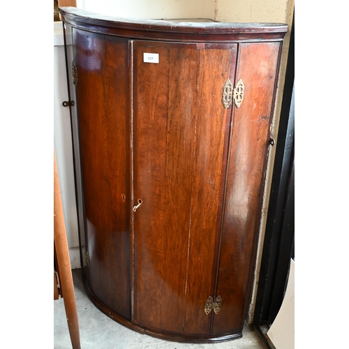 197 - A George III oak barrel front hanging corner cupboard with two doors, 70 cm wide x 98 cm high