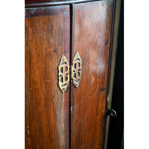 197 - A George III oak barrel front hanging corner cupboard with two doors, 70 cm wide x 98 cm high