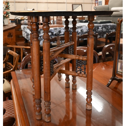 206 - A Middle Eastern engraved brass tray-top table on folding hardwood stand, 66 cm diam x 56 cm high