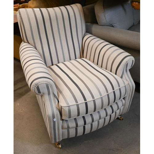 214 - A upholstered armchair by Laura Ashley in 'Luxford Stripe' fabric, on hardwood supports with brass c... 