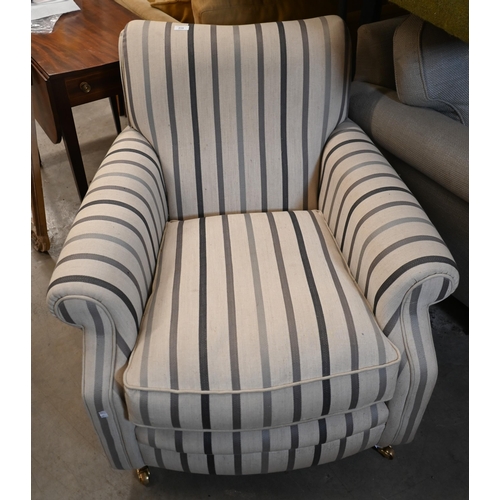 214 - A upholstered armchair by Laura Ashley in 'Luxford Stripe' fabric, on hardwood supports with brass c... 