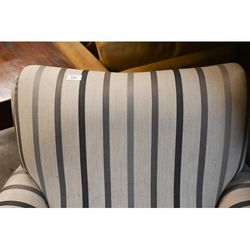 214 - A upholstered armchair by Laura Ashley in 'Luxford Stripe' fabric, on hardwood supports with brass c... 