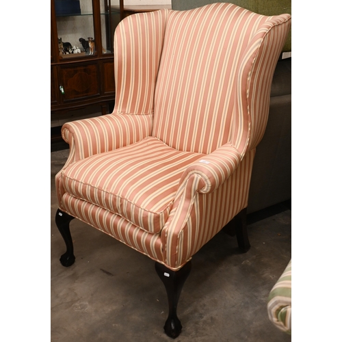 218 - A Georgian-style mahogany framed wingback armchair, pink and cream striped fabric and cabriole front... 