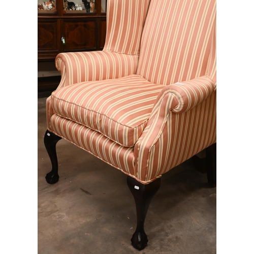 218 - A Georgian-style mahogany framed wingback armchair, pink and cream striped fabric and cabriole front... 