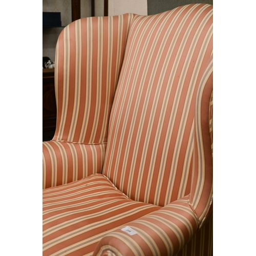 218 - A Georgian-style mahogany framed wingback armchair, pink and cream striped fabric and cabriole front... 