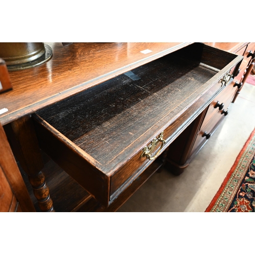 225 - An early 20th century oak buffet with single drawer and open shelves and bobbin turned supports, 92 ... 