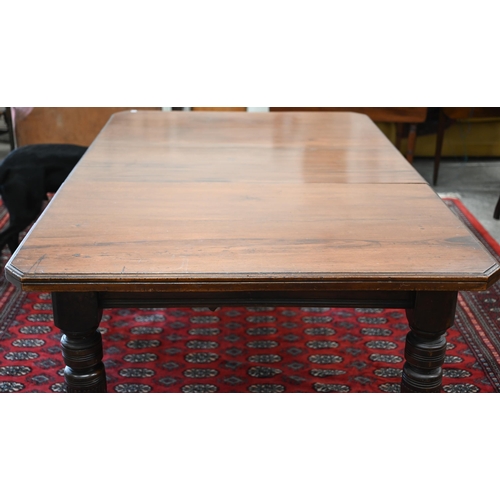 228 - An Edwardian mahogany extending dining table, wind-out canted rectangular top with single leaf on tu... 