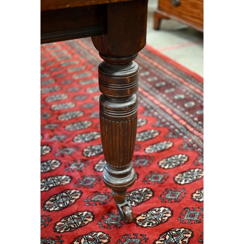 228 - An Edwardian mahogany extending dining table, wind-out canted rectangular top with single leaf on tu... 