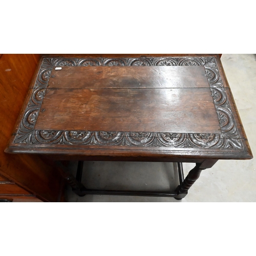 231 - A lunette carved oak side table with turned supports united by stretchers, 75 x 46 x 66 cm high