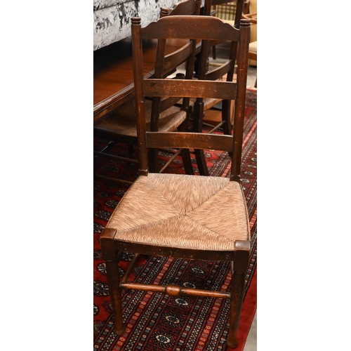 233 - A set of six provincial stained ash ladderback dining chairs with rush seats (6)