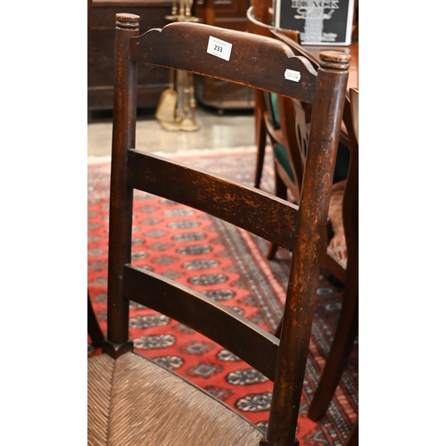 233 - A set of six provincial stained ash ladderback dining chairs with rush seats (6)