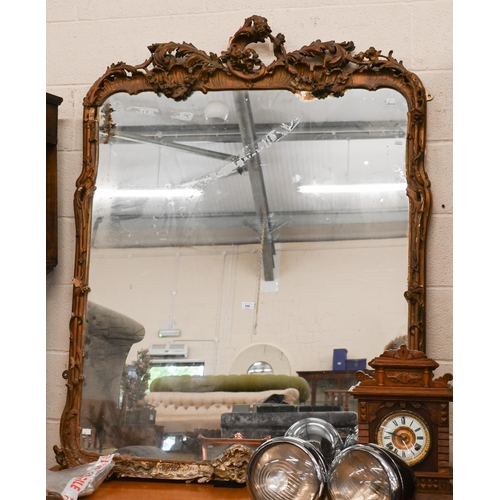 244 - An antique over mantel mirror in decorative giltwood and gesso floral and foliate frame, a/f, 110 cm... 