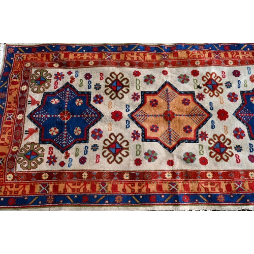 245 - A Caucasian geometric design blue ground runner, 323 x 70 cm to/w a Turkish star medallion cream gro... 