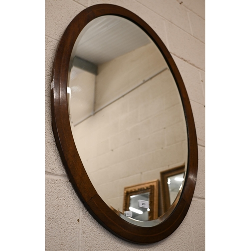 253 - An early 20th century bevelled oval mirror with inlaid mahogany frame, 90 x 66 cm