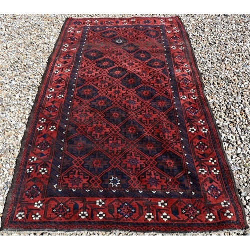 254 - Persian Balouchi rug, brown/red ground with repeating lattice design, 198 x 108 cm