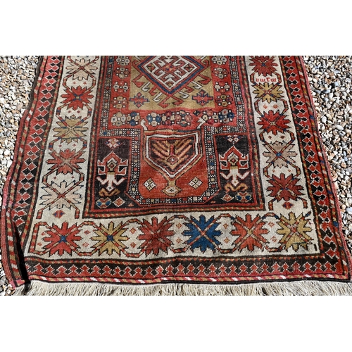 255 - An old Caucasian wide runner of geometric design on terracotta ground with cream border, 288 x 116 c... 