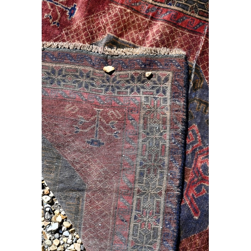 257 - A Persian Baluchi rug, double medallion on blue/brown ground, 167 x 98 cm to/w a Persian Hamadan rug... 