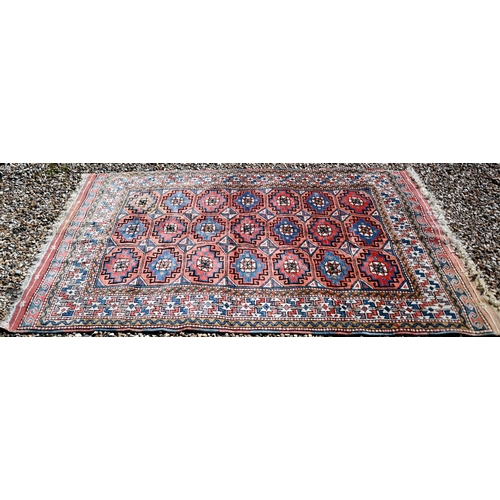 258 - A Turkish gul-tile design terracotta ground rug, cream repeating border, 210 x 130 cm