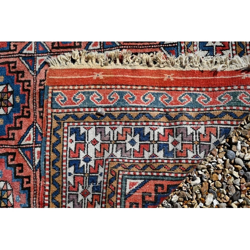 258 - A Turkish gul-tile design terracotta ground rug, cream repeating border, 210 x 130 cm