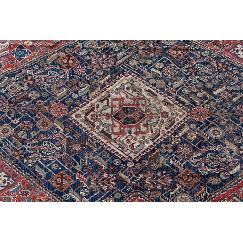 262 - A worn Persian Shiraz kelleigh rug, beige diamond medallion and stylised floral design on blue groun... 