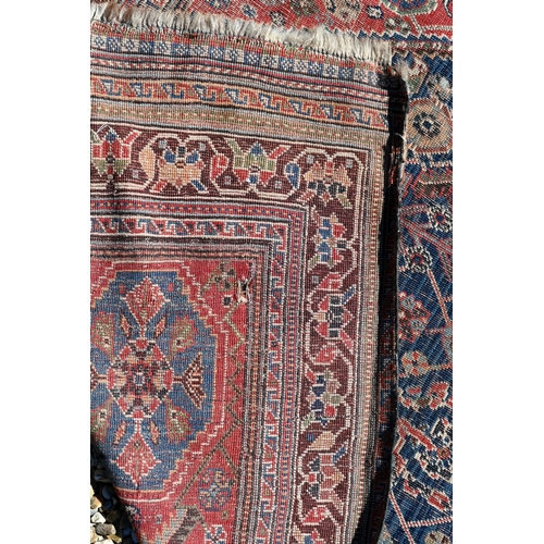 262 - A worn Persian Shiraz kelleigh rug, beige diamond medallion and stylised floral design on blue groun... 