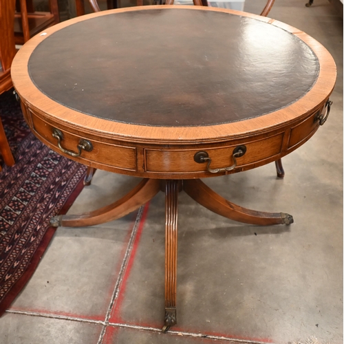 264 - A Regency style mahogany drum table with leather top and alternating drawers and dummy draewrs on tu... 