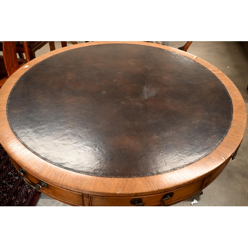 264 - A Regency style mahogany drum table with leather top and alternating drawers and dummy draewrs on tu... 