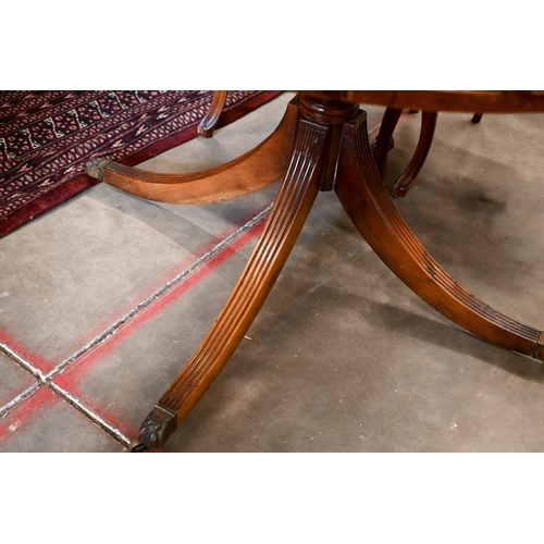 264 - A Regency style mahogany drum table with leather top and alternating drawers and dummy draewrs on tu... 