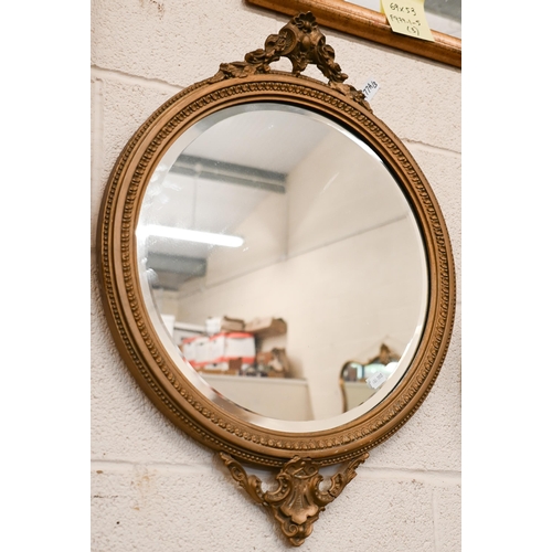 270 - # A bevelled circular wall mirror in moulded giltwood and gesso frame, 64 cm high x 50 cm wide