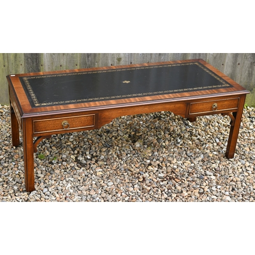 310 - # A mahogany veneered two drawer coffee table with gilt tooled leather top, 124 cm wide x 50 cm deep... 