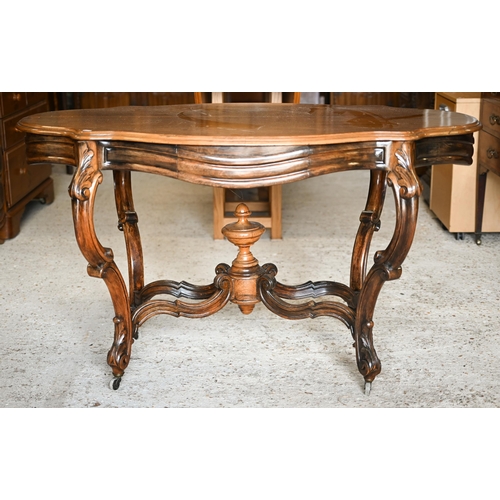 313 - A Victorian style cetnre table with shaped top and two frieze drawers on stretchered carved supports... 