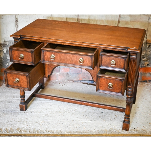 326 - an oak and walnut five drawer desk, raised on baluster turned supports united by an 'H' stretcher ba... 