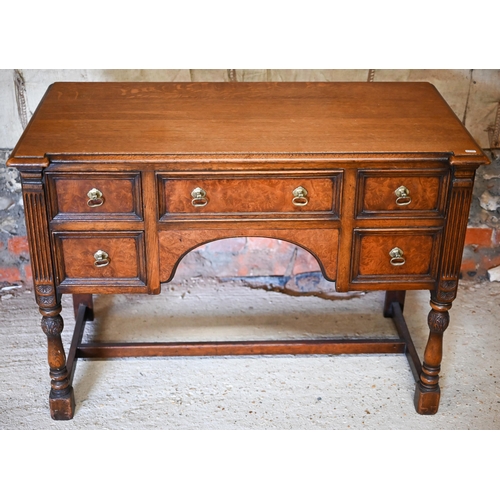 326 - an oak and walnut five drawer desk, raised on baluster turned supports united by an 'H' stretcher ba... 