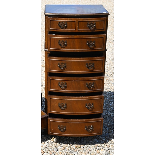 332 - A reproduction diminutive bowfront chest of six long graduated drawers, raised on shaped bracket fee... 