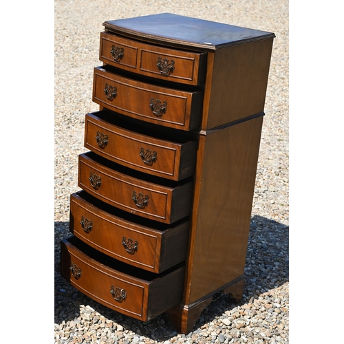 332 - A reproduction diminutive bowfront chest of six long graduated drawers, raised on shaped bracket fee... 