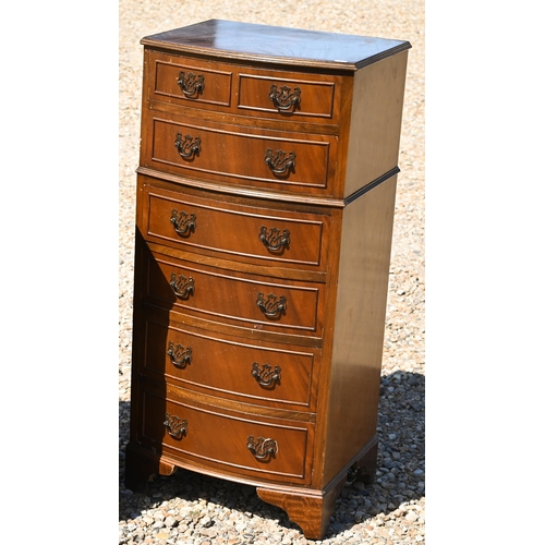 332 - A reproduction diminutive bowfront chest of six long graduated drawers, raised on shaped bracket fee... 