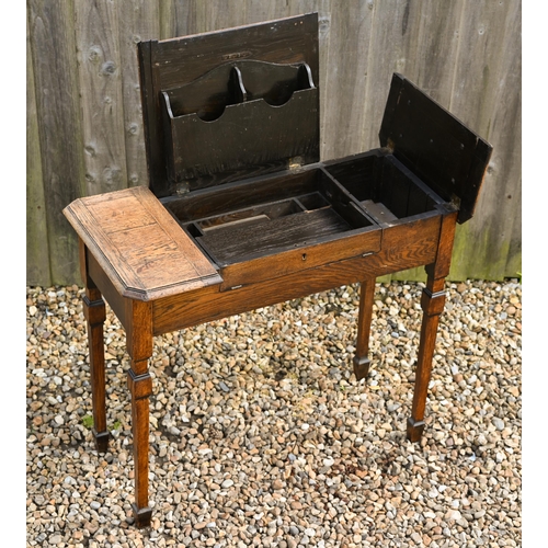 336 - An Arts & Crafts period oak triple fold over top desk, with interesting interior, raised on squa... 