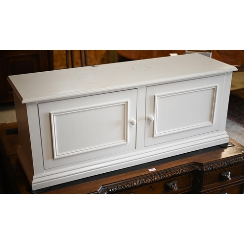 340 - A white painted twin door low cabinet, on a plinth base, 120 cm x 38 cm x 47 cm h