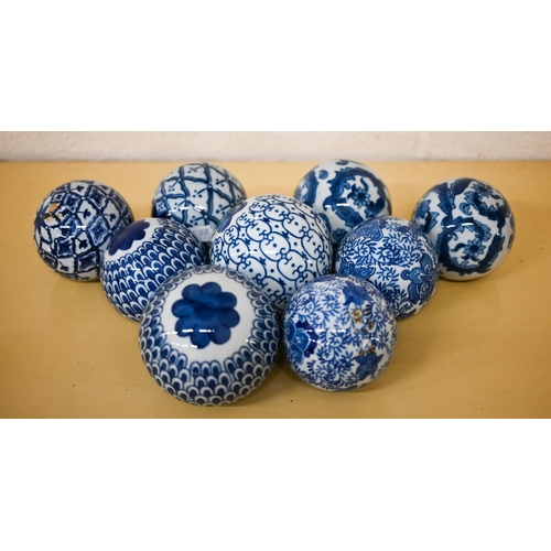 409 - A blue and white pottery stick stand, to/w nine carpet-bowls, a tureen and cover and four vases and ... 