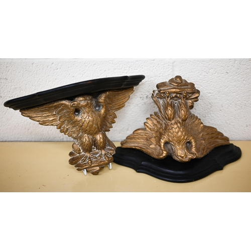 509 - A pair of ebonised and gilt composite wall brackets supported by spread eagles 31 cm wide, to/w a fo... 