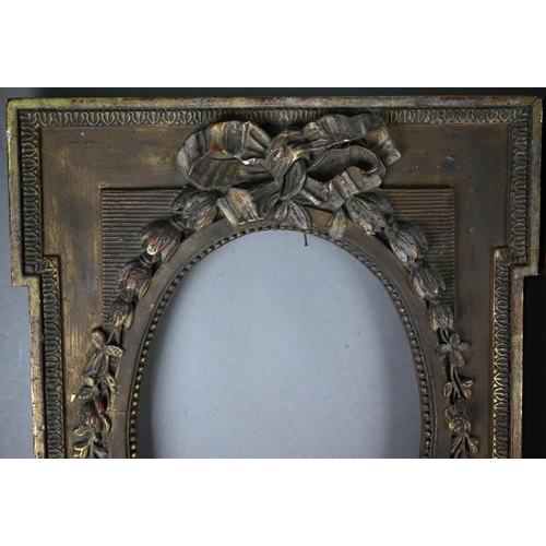 525 - A pair of 19th century gilt gesso frames with oval apertures, floral and ribbon mouldings, 38 x 28 c... 