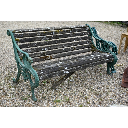 68 - An old weathered teak slat garden bench, with cast iron dragon arm ends, 155 cm wide, to/with a pair... 