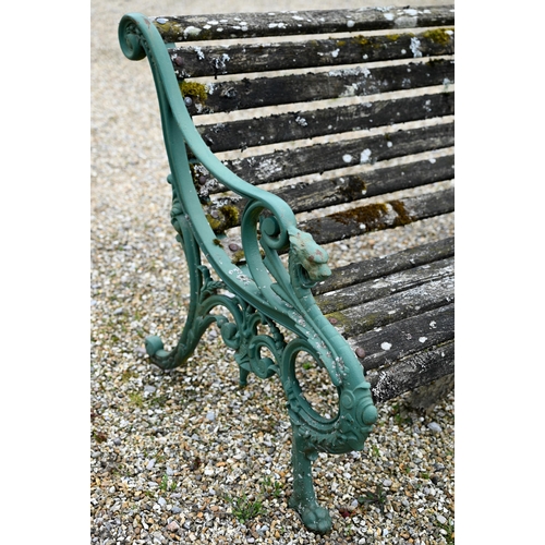 68 - An old weathered teak slat garden bench, with cast iron dragon arm ends, 155 cm wide, to/with a pair... 