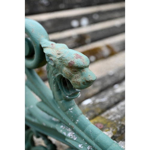 68 - An old weathered teak slat garden bench, with cast iron dragon arm ends, 155 cm wide, to/with a pair... 