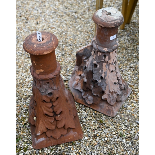 71 - A pair of old weathered terracotta finial ridge tiles by Blanchard & Co, 53 cm h (2)