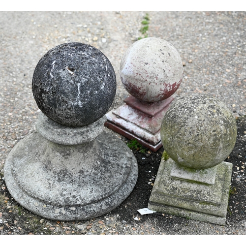 76 - A trio of weathered cast stone ball finials and bases, sizes and designs differ (3)