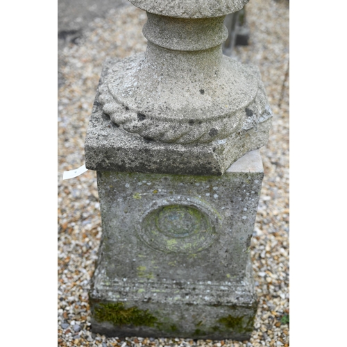 8 - An old weathered cast stone ball finial raised on associated square plinth base